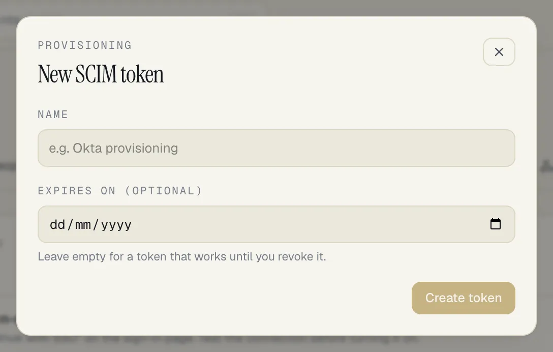 The New SCIM token sheet: a Name field with the example Okta provisioning, an optional Expires on date with the hint to leave it empty for a token that works until you revoke it, and a Create token button.